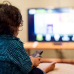Young Indian boy watching television