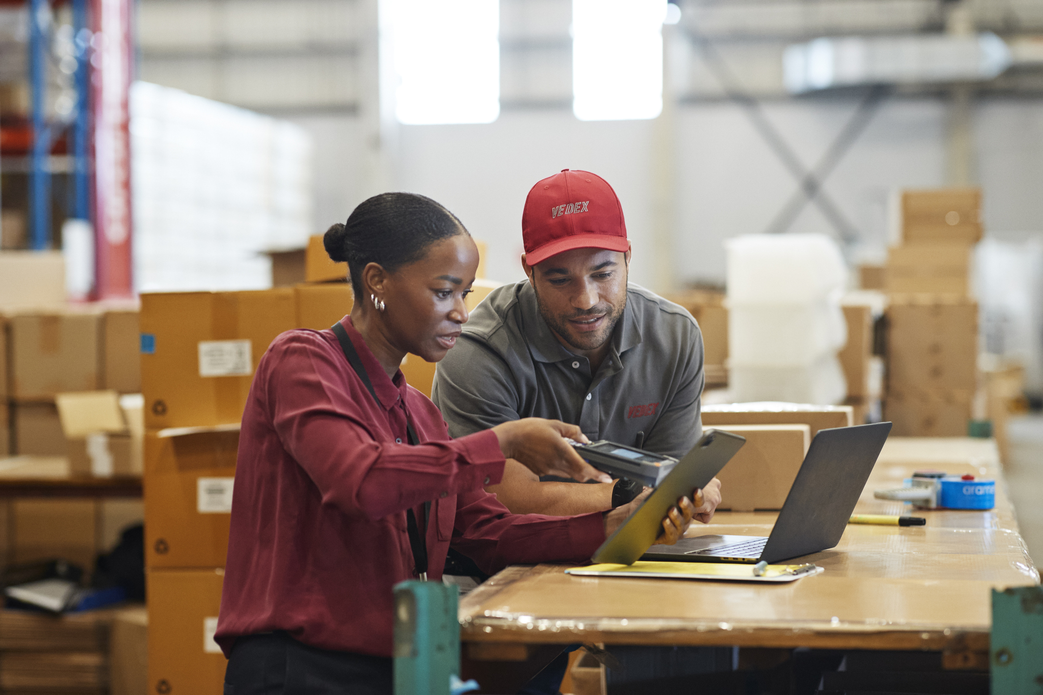 Female manager using bar code reader on digital tablet
