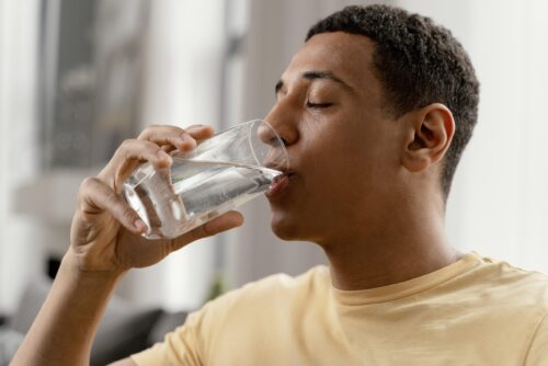 portrait-man-home-drinking-glass-water
